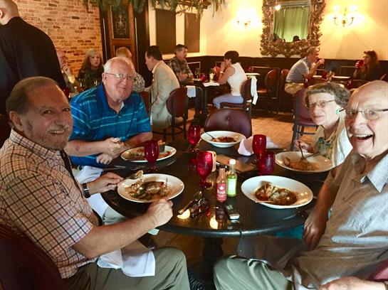 A group of people sitting at a table eating food