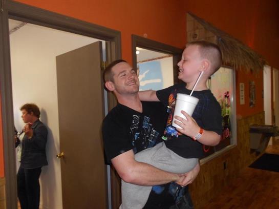 A man holding a boy in his arms