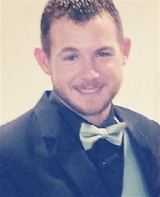 A man in a suit and bow tie