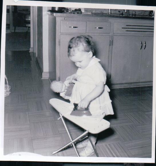 A baby playing with a doll