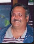 A man with a mustache smiling