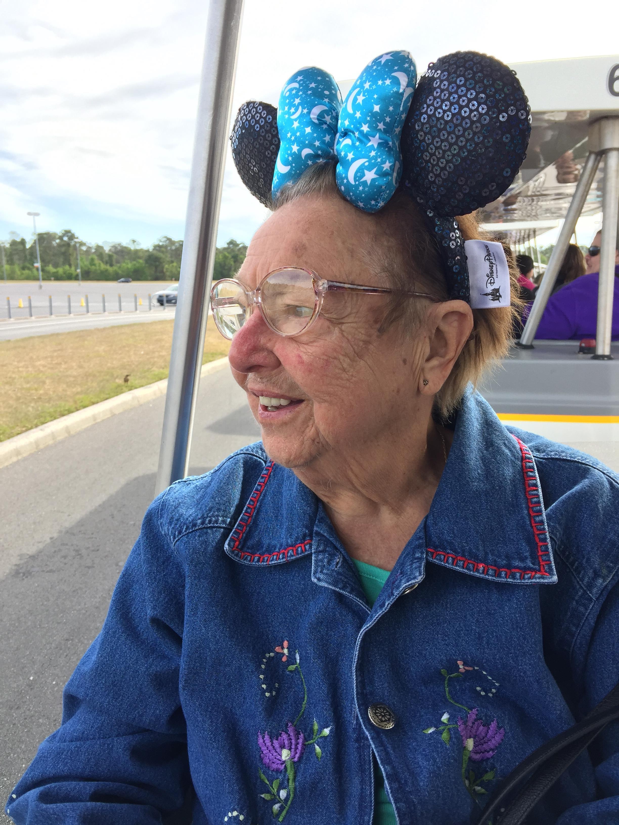 An old woman wearing a mouse headband