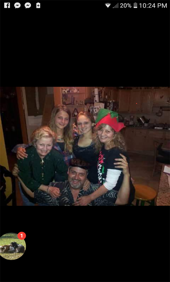 Five friends enjoy a festive night together in a cozy home with cheerful expressions and hats.