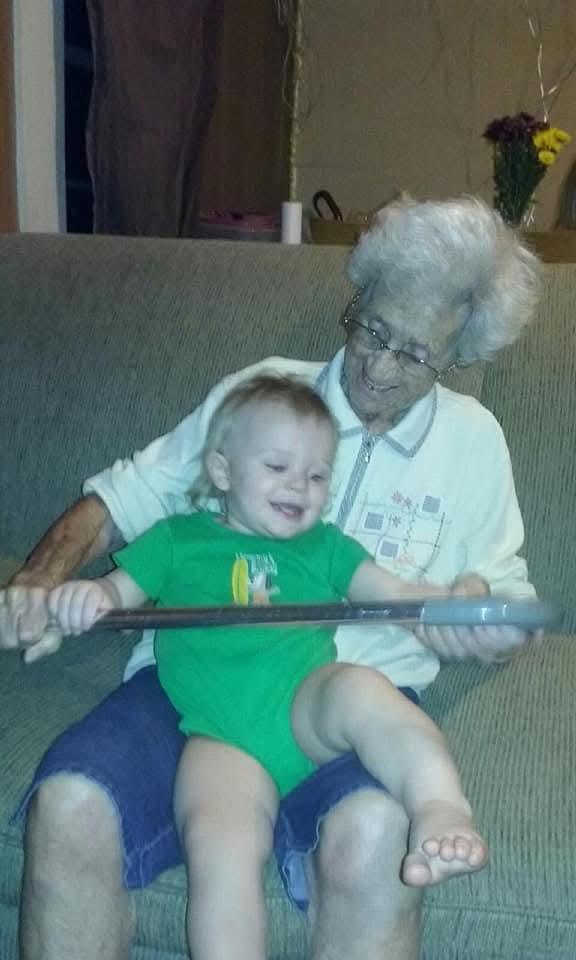 An old woman holding a baby