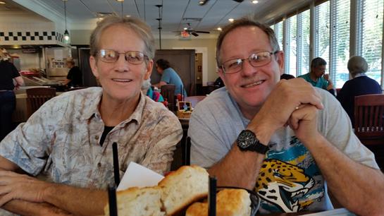 Friends relax at a restaurant, enjoying food and each other's company in a lively vibe.