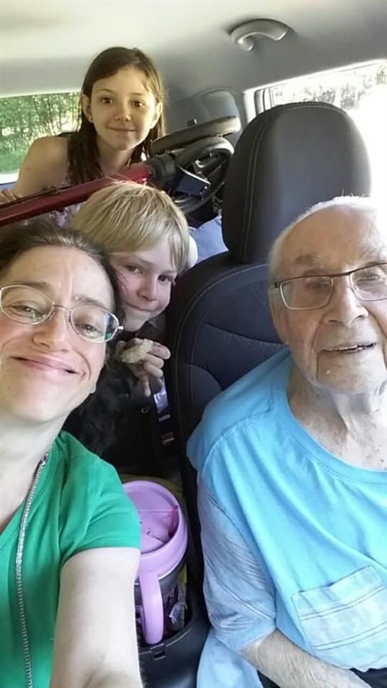 Family members enjoy a fun outing together while seated in a vehicle, sharing smiles and laughter.