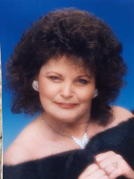 Confident woman showcases her ski while wearing elegant jewelry in a studio.