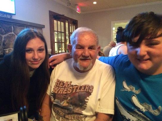 Three relatives enjoy a moment together at a cozy restaurant during a family gathering.