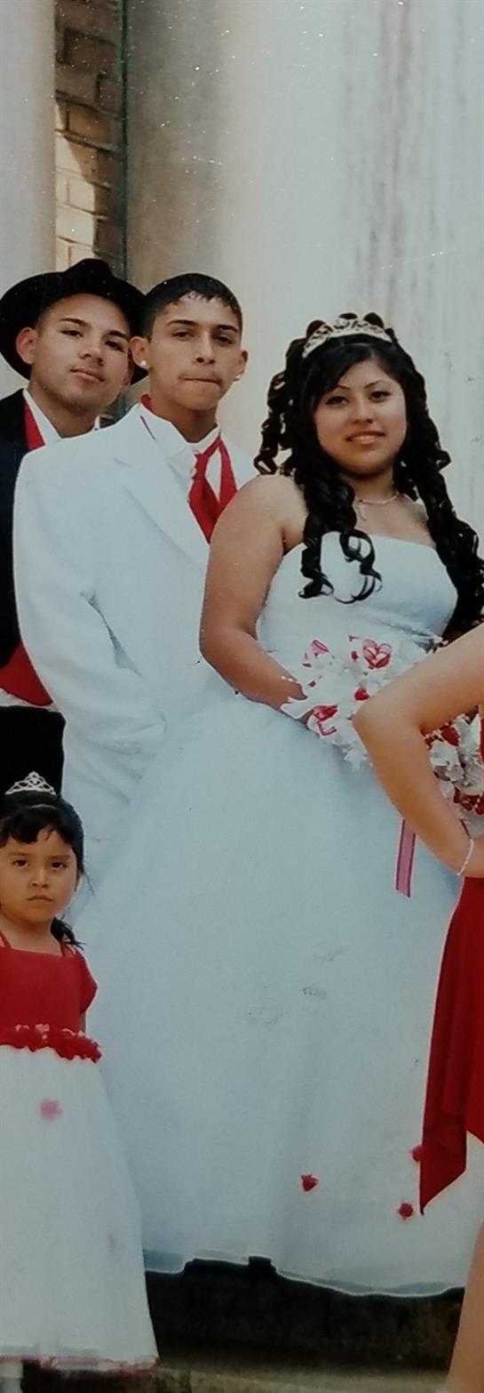 Guests surround a joyful couple in wedding attire, celebrating with laughter and smiles.