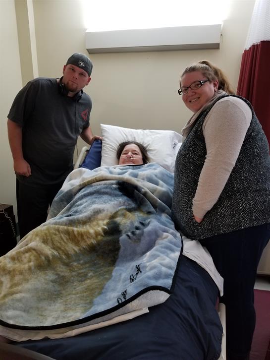 Friends are visiting a patient in a hospital room, offering companionship and comfort.