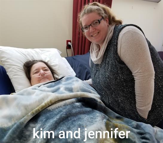 Kim rests comfortably in bed while Jennifer offers encouragement and companionship during recovery.
