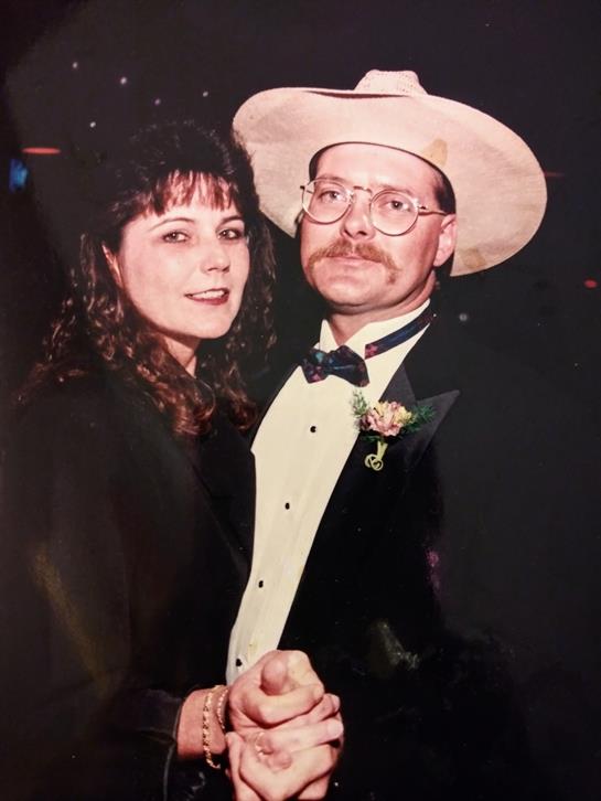 A couple dressed in formal attire enjoys a night of dancing at an elegant gathering.