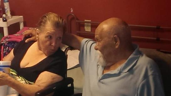 Two seniors engage in a warm discussion, showing genuine connection and companionship.