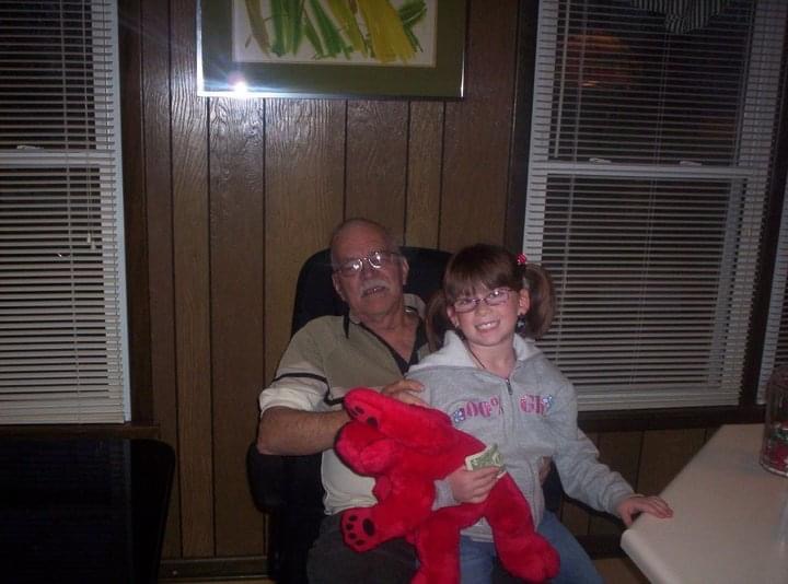 A man and girl sitting in a chair