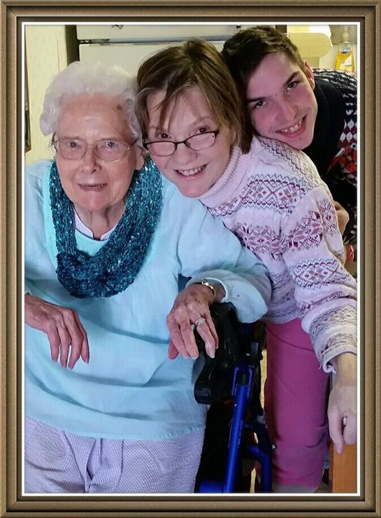 Three people share a joyful moment while posing together in a warm, welcoming space.