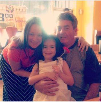 A family shares a joyful embrace in a cafe, radiating love and happiness together.