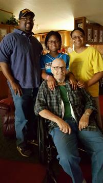 Four family members pose together in a warm, inviting living room filled with joy and laughter.