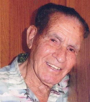 An elderly man with a joyful expression is enjoying his time indoors with warm lighting.