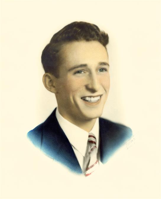 A young man in a classic suit smiles brightly, creating a cheerful vibe.