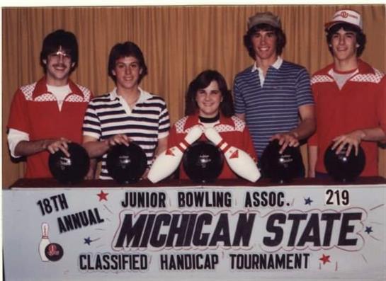 Participants proudly display their championship trophies at the Michigan State bowling event.