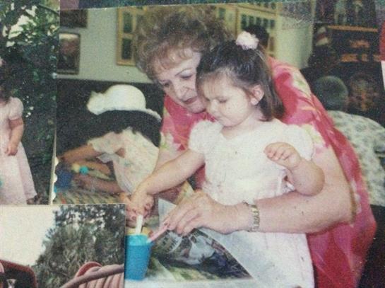Grandmother guides granddaughter in painting craft activities during a joyful afternoon.