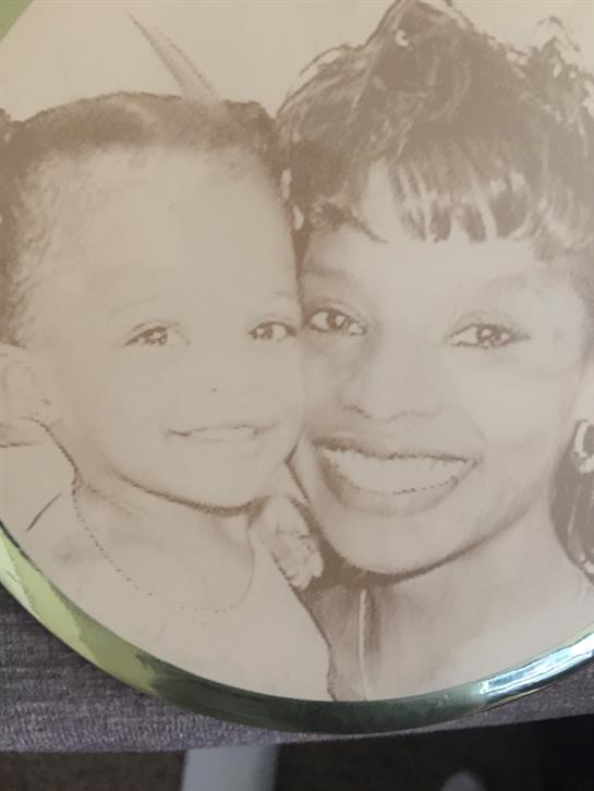 A mother and her child share bright smiles, radiating love and happiness.