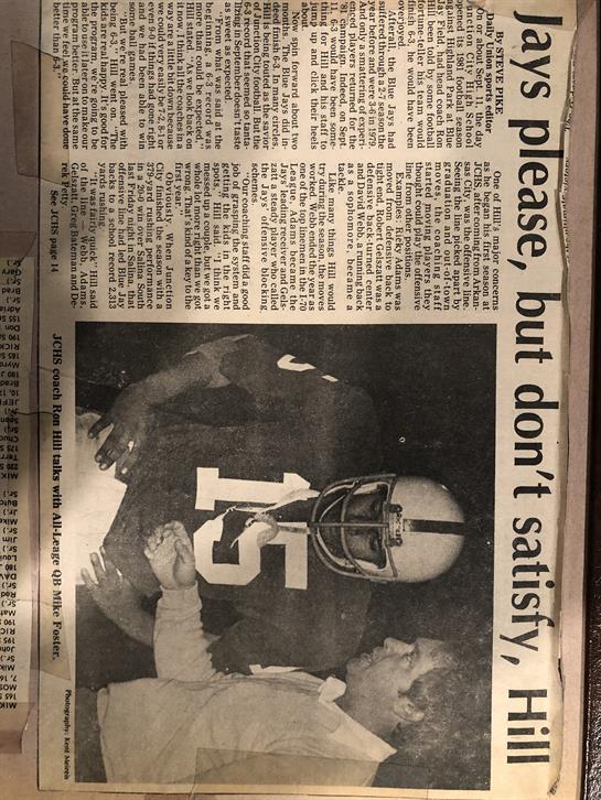 A football player connects with fans and teammates during an intense match on the field.