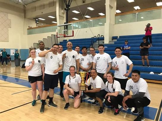 Players celebrate with their championship trophy at the sports center after an exciting tournament.