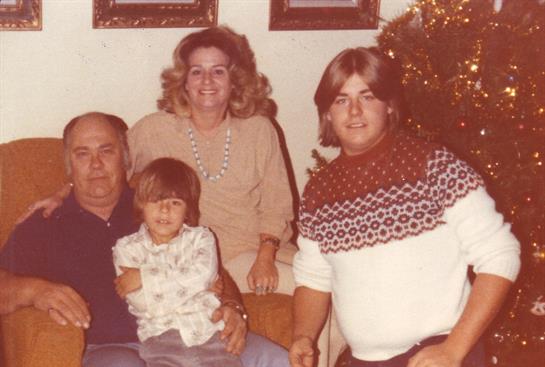 A family enjoys a joyful gathering near a decorated Christmas tree, creating cherished memories.
