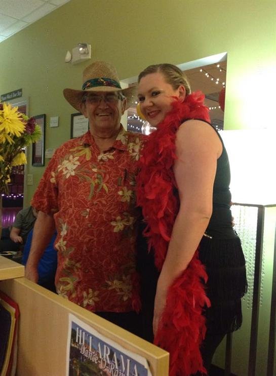 Guests enjoy a tropical-themed celebration with colorful outfits and festive decorations.