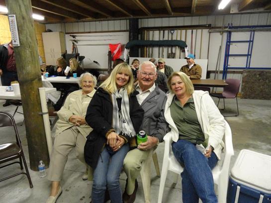 Group of friends seated together, sharing smiles and laughter in a local gathering space.