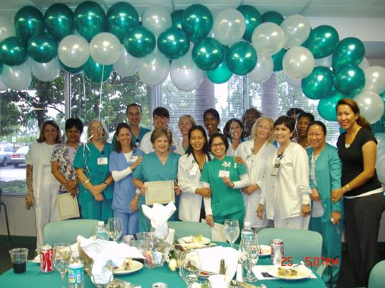 Hospital staff gather to celebrate their achievements with food, decorations, and camaraderie.