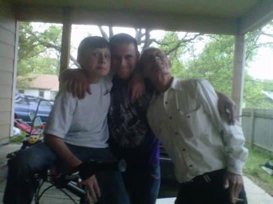 Friends pose together on a porch, smiling and having fun as they enjoy a sunny afternoon.