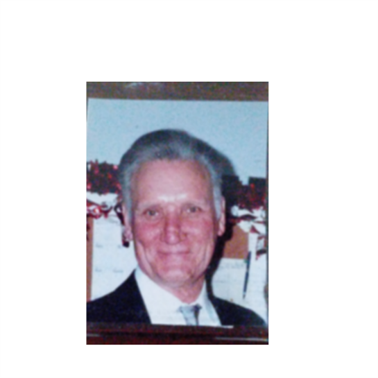 A joyful elderly man dressed in a suit smiles warmly, enjoying a winter evening celebration.