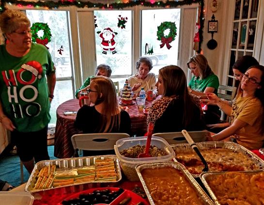A group of family members enjoys a joyful holiday gathering filled with delicious food and laughter.