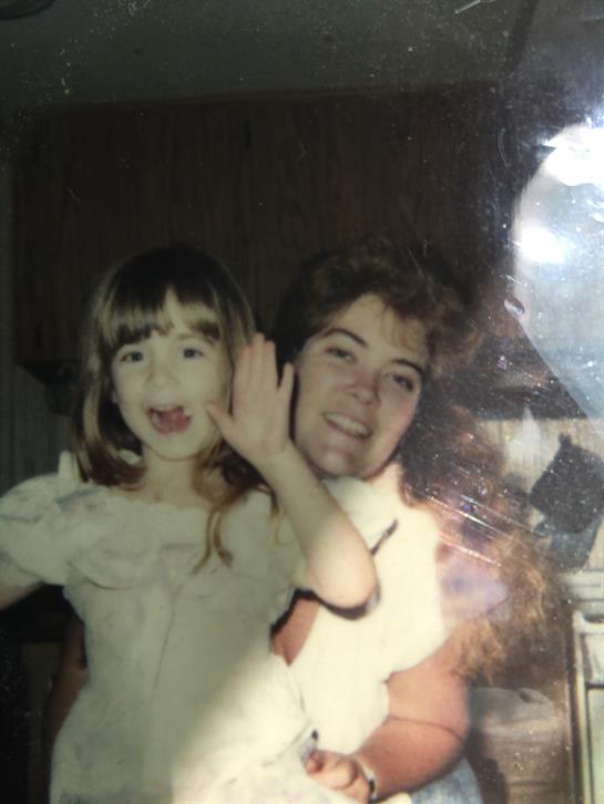 Happy moments captured as a little girl waves joyfully with an adult in a warm indoor atmosphere.