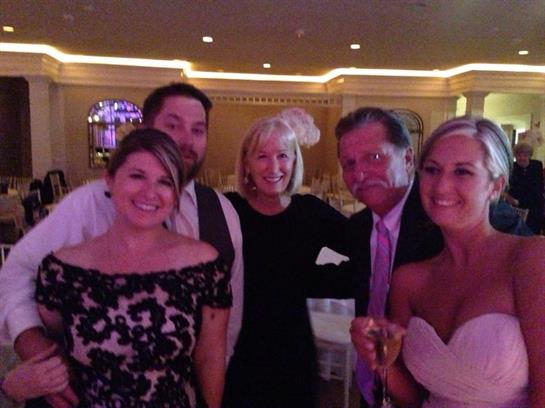 Group of friends smiling and enjoying a memorable moment together during a gathering.