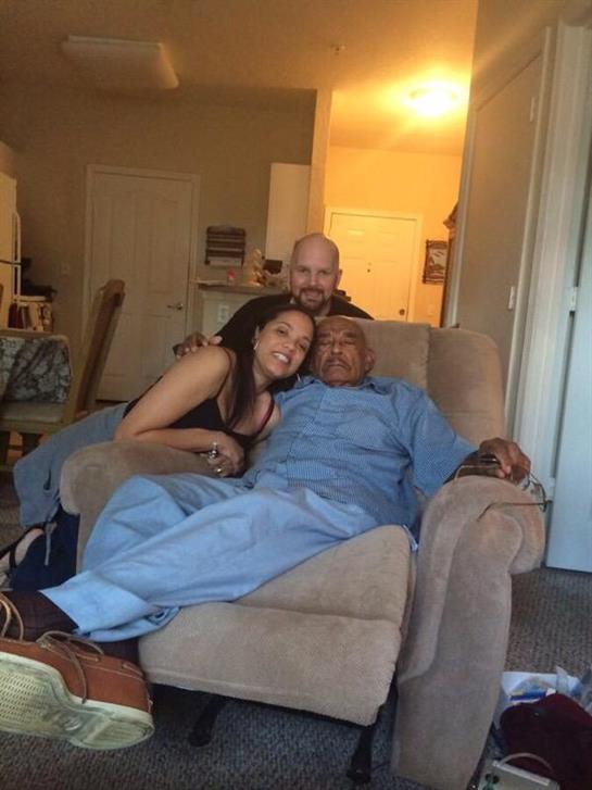 A joyful moment with friends relaxing together on a couch in a warm, inviting living room.