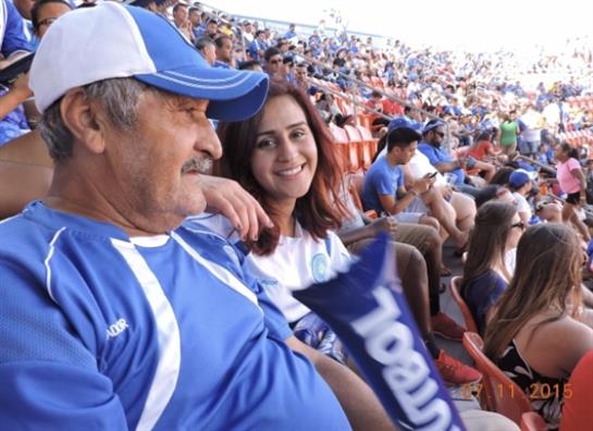 Two fans show their enthusiasm for the game, celebrating together in the lively crowd.