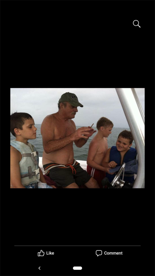 Four boys and their grandfather enjoy a fishing outing, sharing laughter and learning together.
