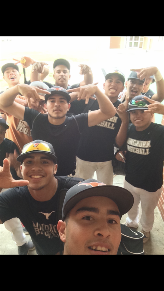 Group of young baseball players celebrates success with joyful poses and gestures after a game.