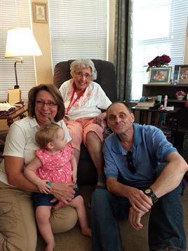 Four family members enjoy quality time in a warm and inviting living room.