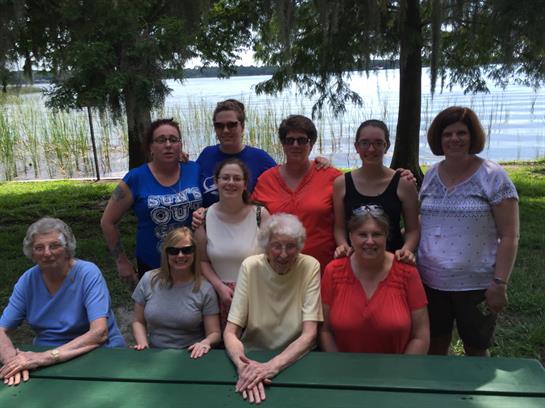 A cheerful gathering of friends and family enjoying a sunny day by the lake in summer.