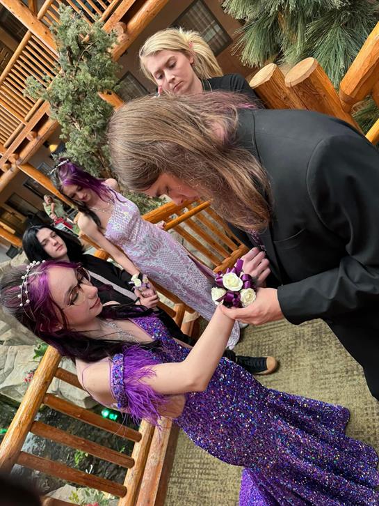 Friends celebrate together with thoughtful gift exchanges while dressed in elegant outfits outdoors.