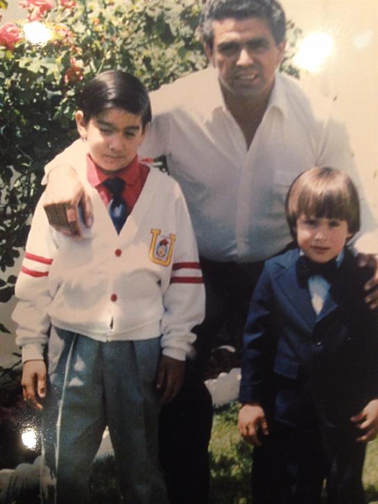 A man and two boys posing for a picture