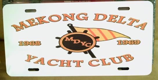 A colorful sign showcases the yacht club's name and logo on a bright day by the water.