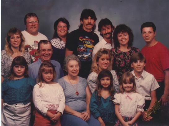 A large family gathers for a memorable group portrait, showcasing love and togetherness.