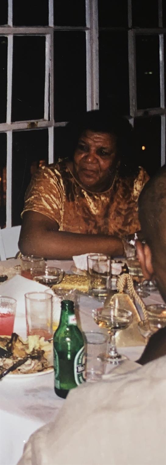 A joyful gathering among friends, sharing drinks and delicious food during an evening celebration.