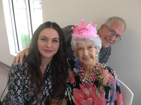 Family members celebrate a special birthday with smiles, laughter, and festive decorations together.