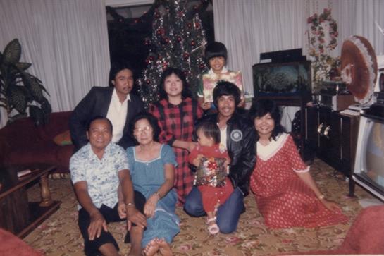 Family enjoys time together during Christmas with decorations and a cozy atmosphere at home.